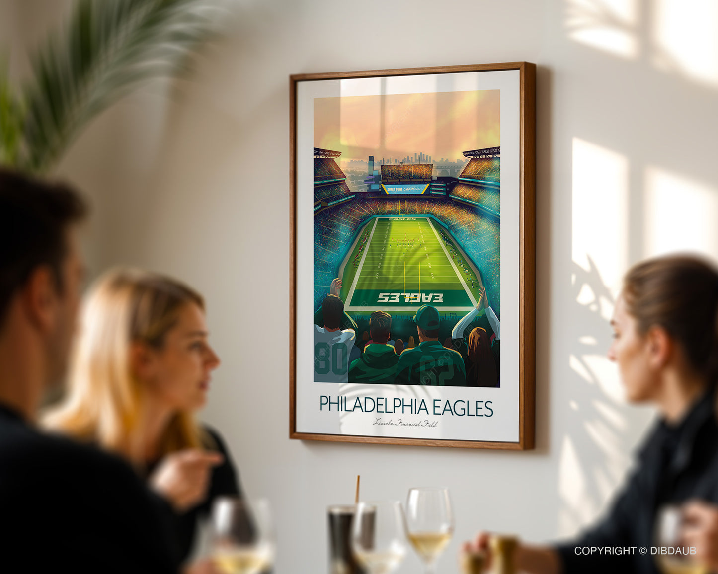 Framed Philadelphia Eagles sports poster on a wall with people sitting at a table below.