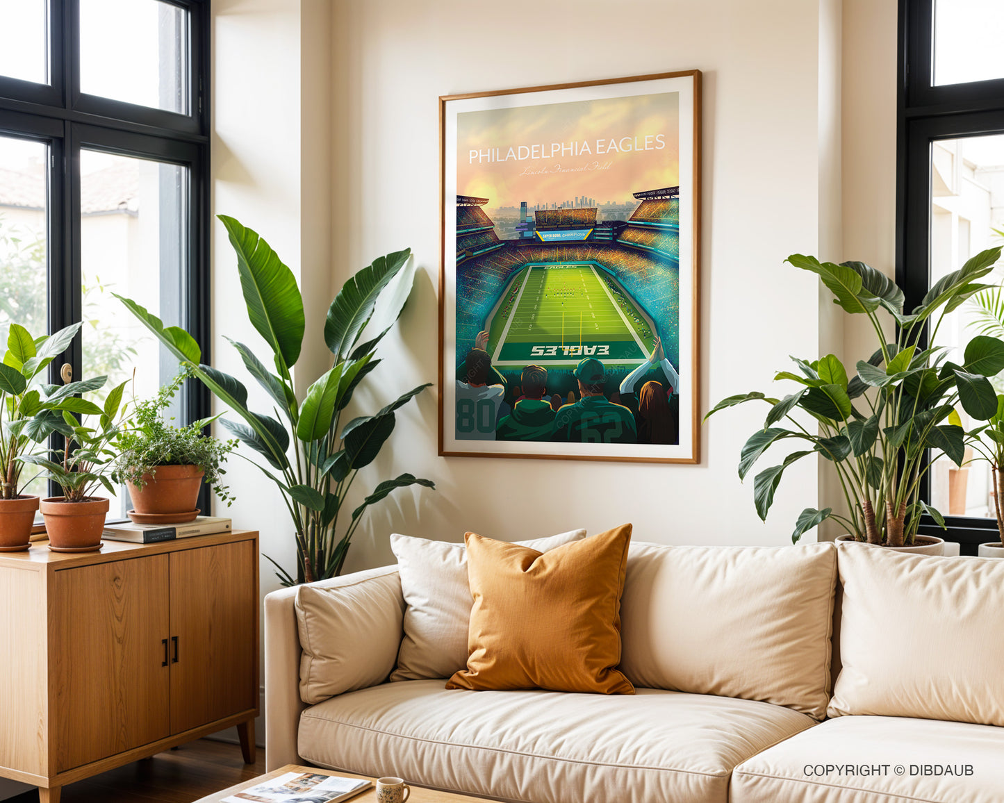 Living room with a beige sofa, decorative pillow, and framed artwork of Philadelphia Eagles American football stadium.