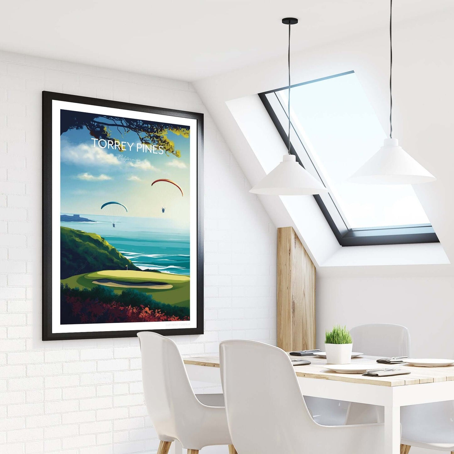 Golf course poster of Torrey Pines, on a kitchen wall beside a dining table and window.