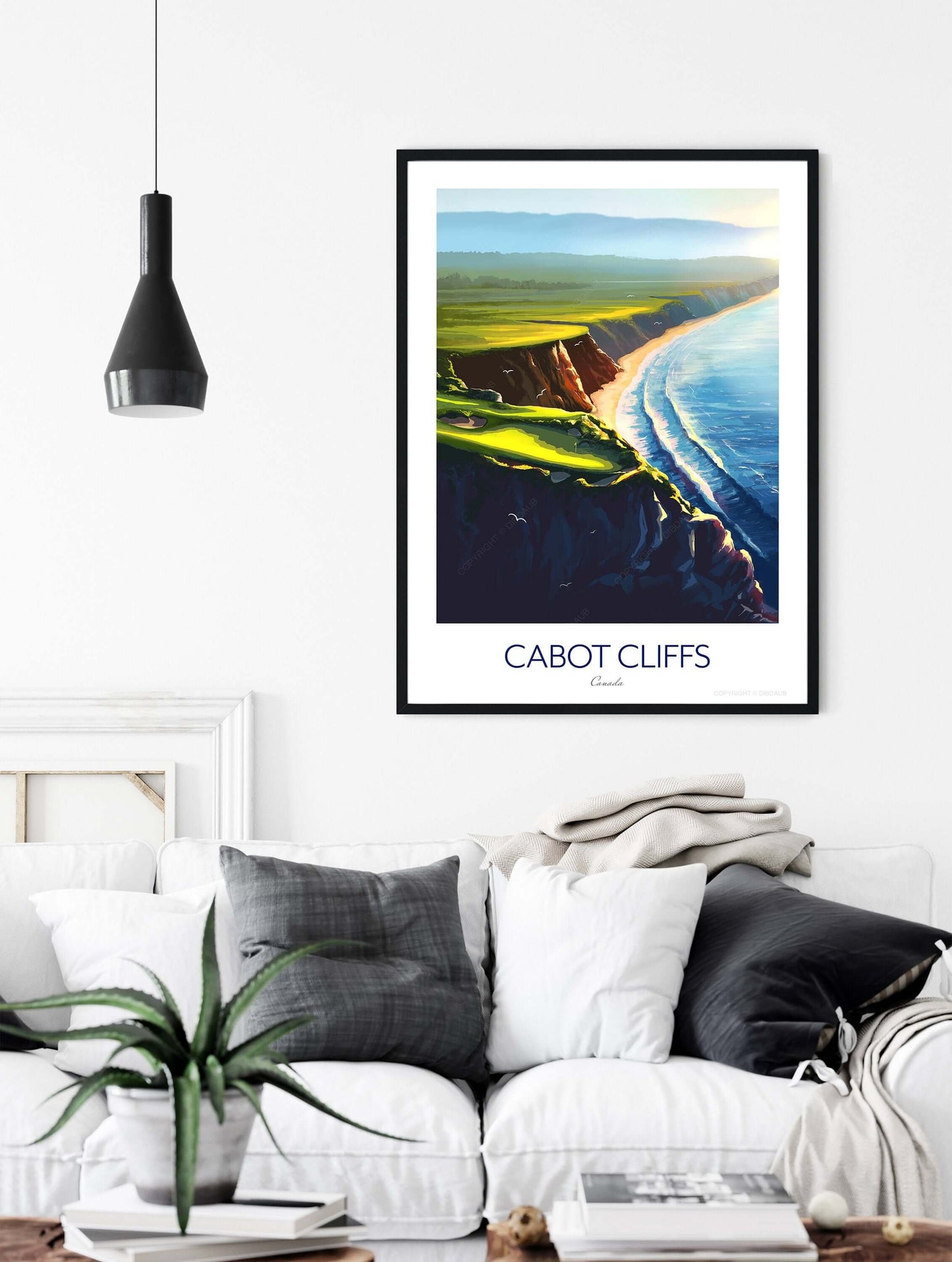 Golf print of Cabot Cliffs in a black frame above a sofa in a living room.