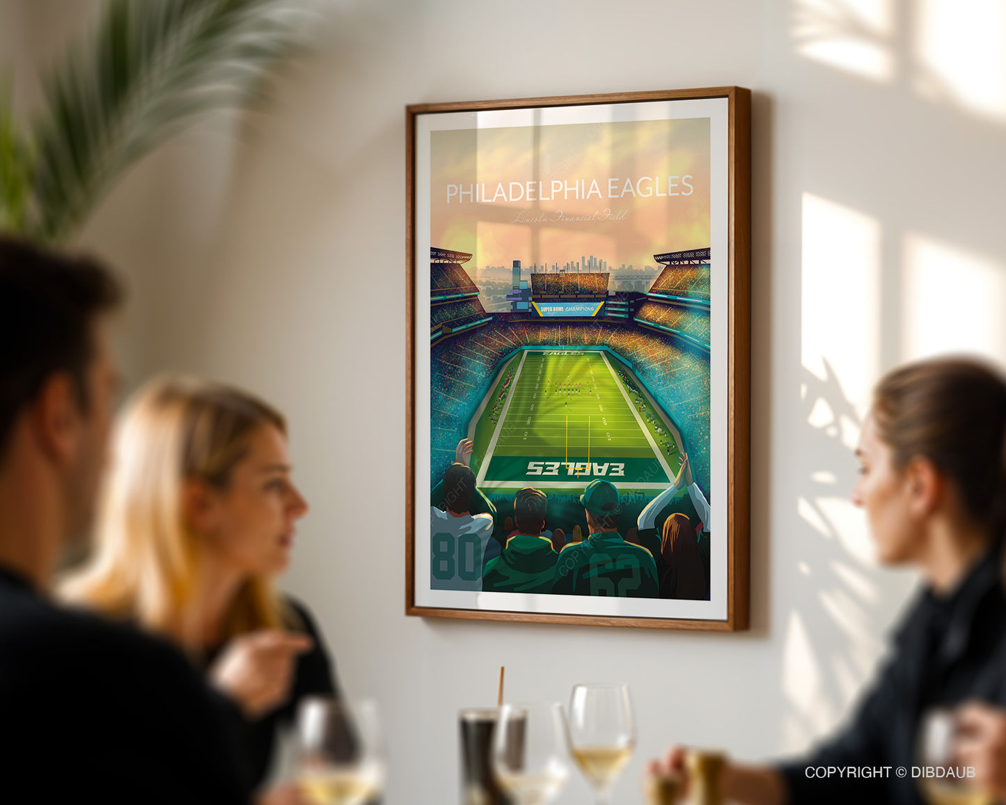 Framed artwork of Philadelphia Eagles football stadium in a dining room with people.