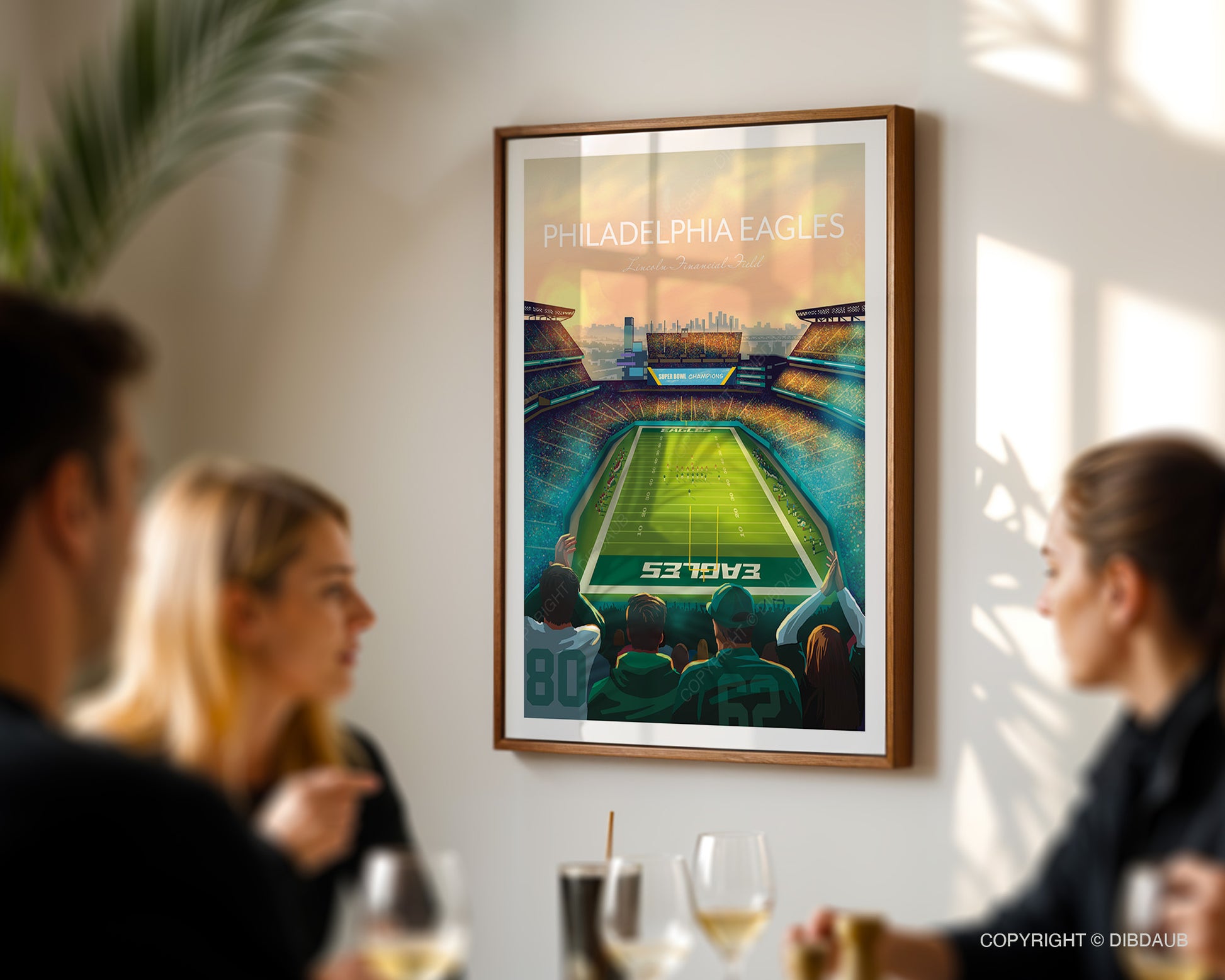Framed artwork of Philadelphia Eagles football stadium in a dining room with people.