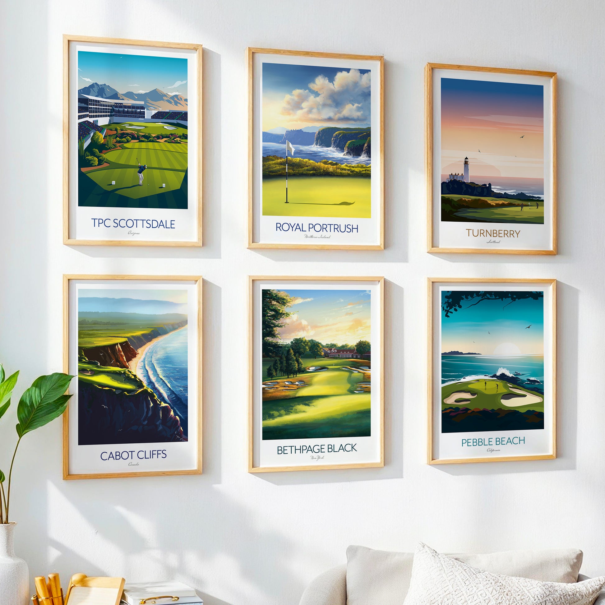 Framed golf course posters on a wall with a plant and sofa in the foreground.