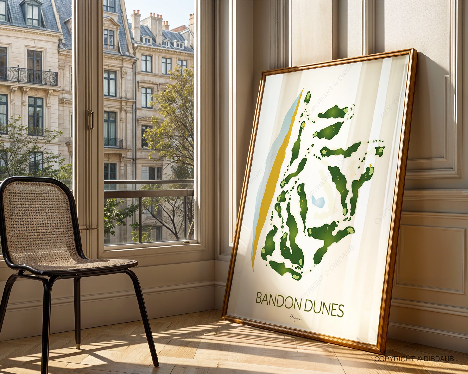 Framed 'Bandon Dunes' golf course map in a room with large windows and a chair.
