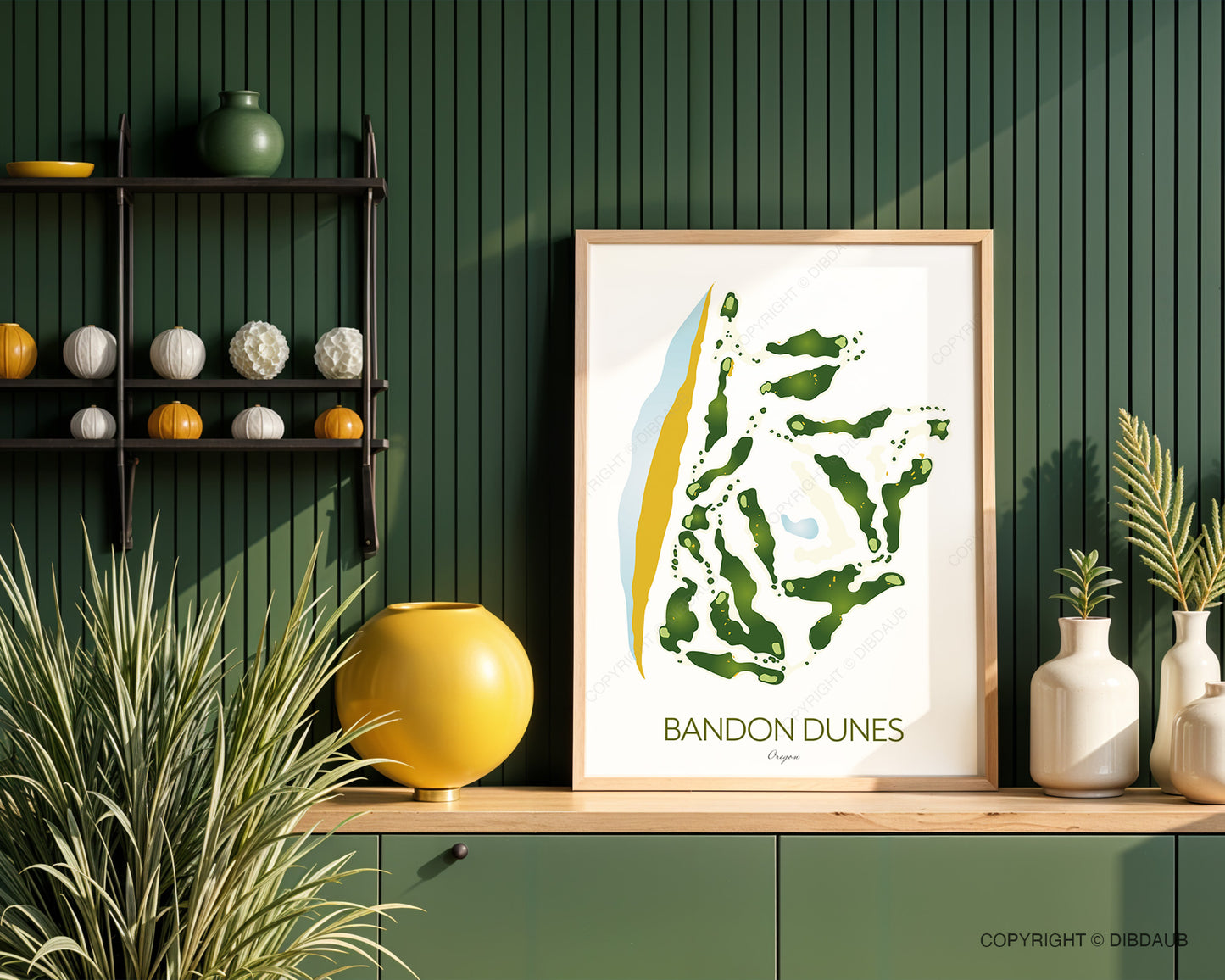 Framed artwork of Bandon Dunes golf course layout on a wooden shelf against a green wall with decorative items.