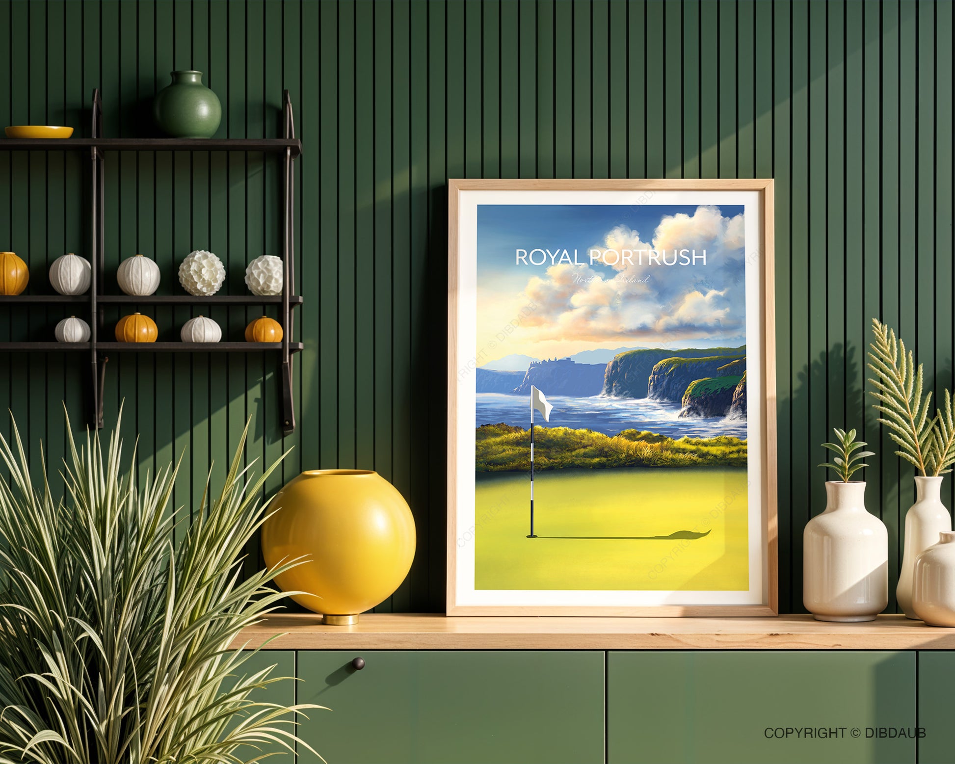Framed artwork of Royal Portrush golf course in a kitchen with a green wall and decorative items.