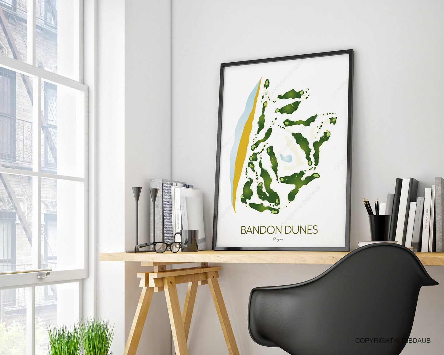Framed map of Bandon Dunes golf course on a desk with a modern office setting.