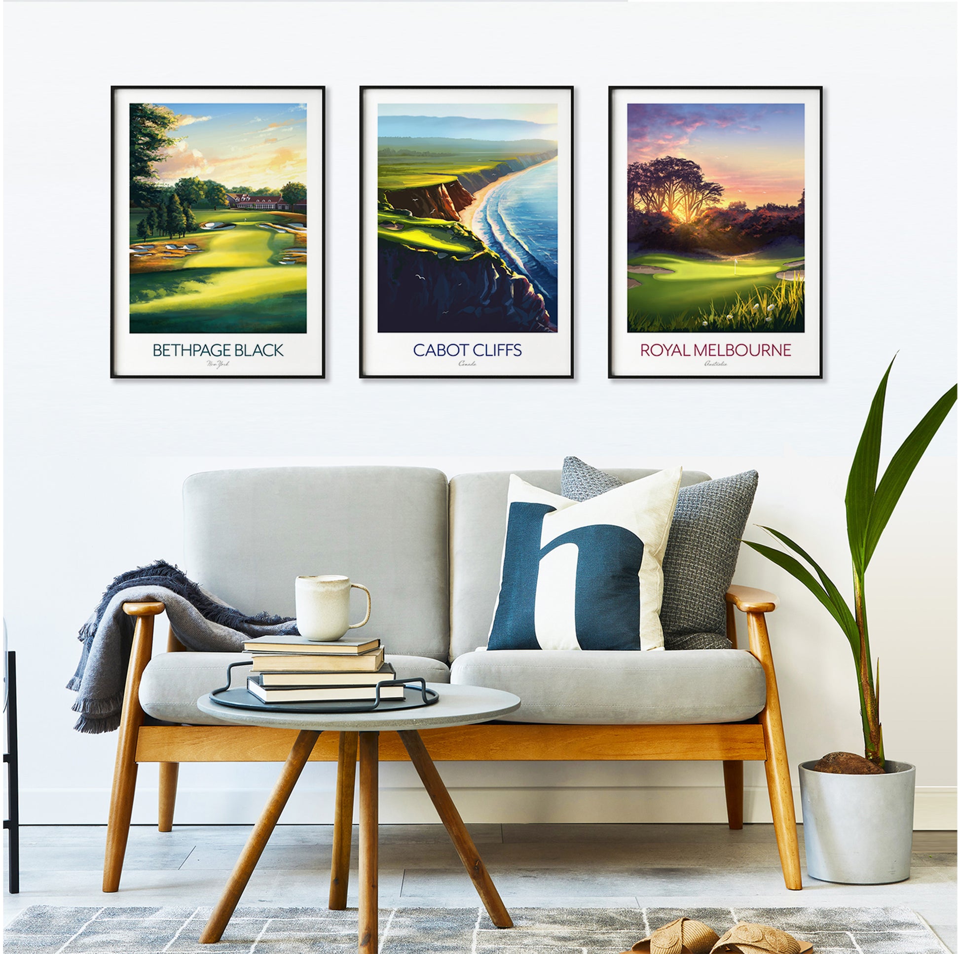 Living room with a sofa, coffee table, and three framed golf course prints on the wall.