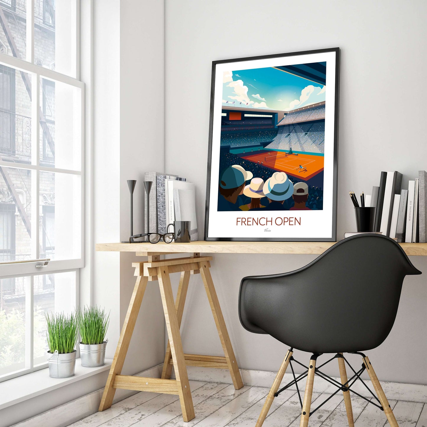 Framed French Open tennis print displayed on a home study IKEA trestle desk.