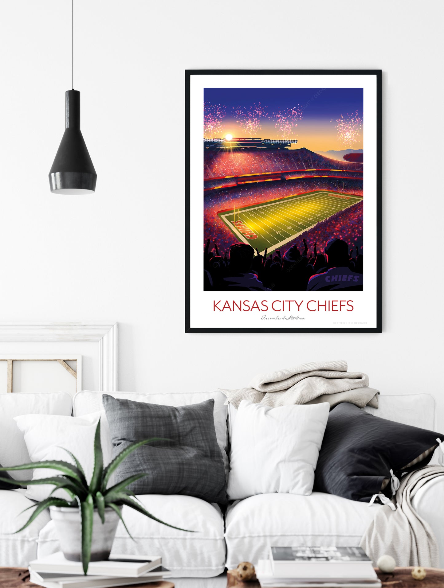 Framed artwork of a football stadium with 'Kansas City Chiefs' text in a living room setting.