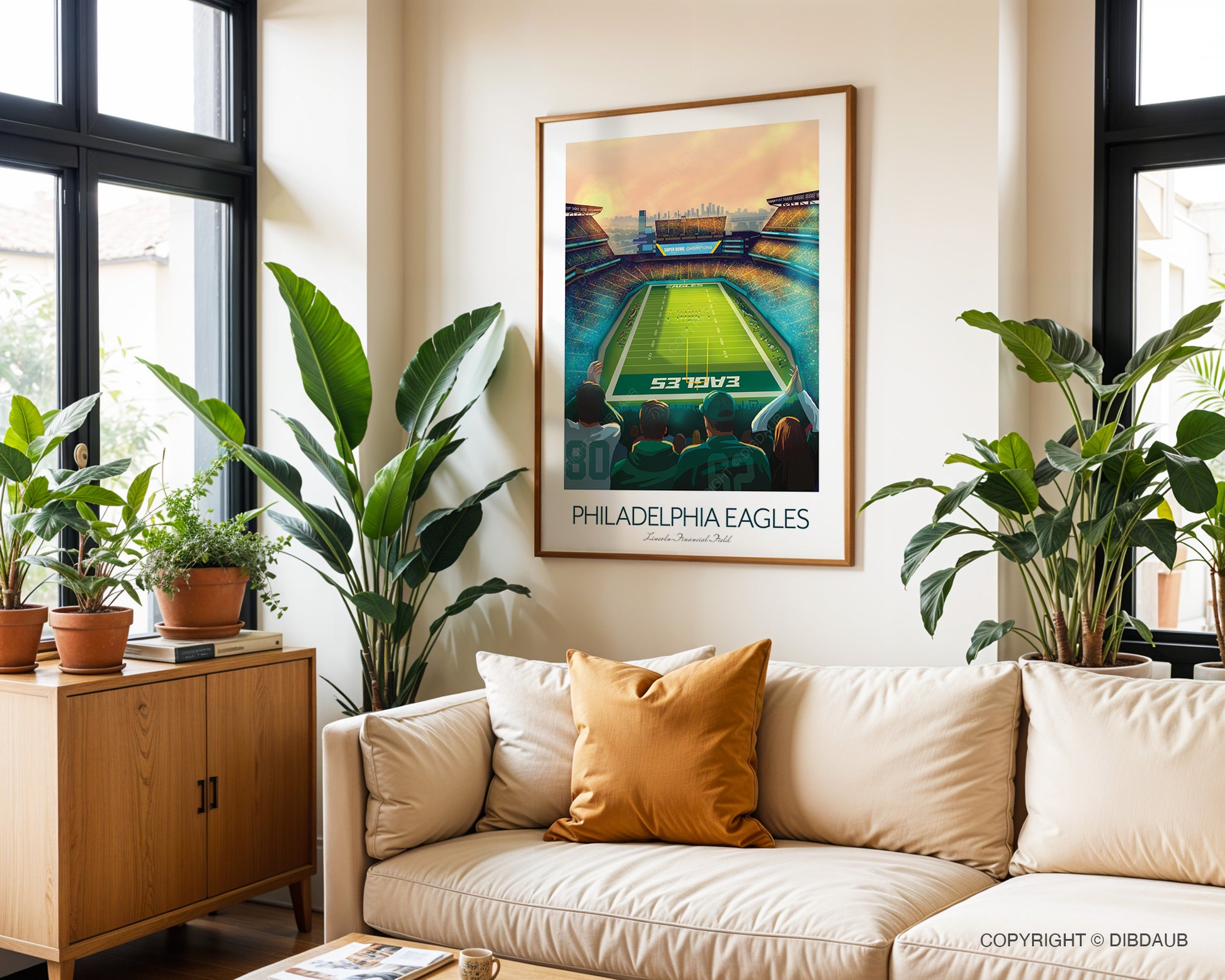 Living room with a couch, plants, and a framed picture of a Philadelphia Eagles Stadium.