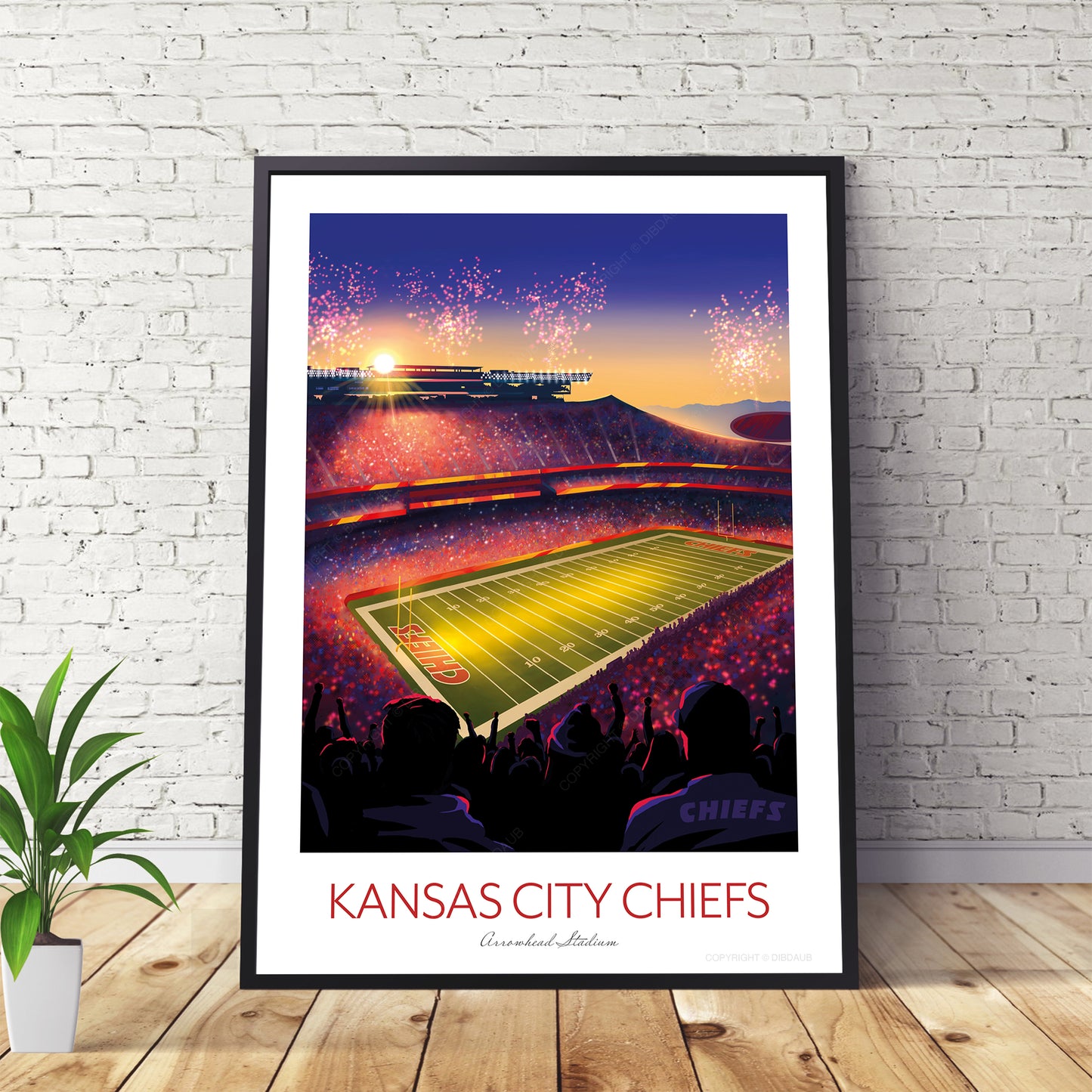 Framed artwork of a football stadium with 'Kansas City Chiefs' text on a white brick wall.