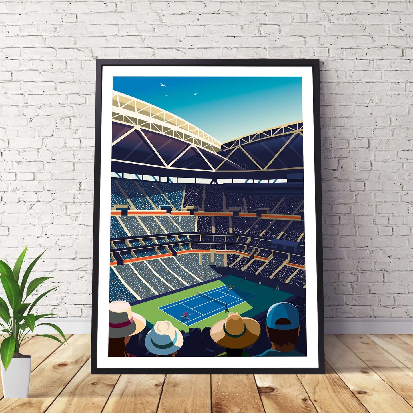 US Open tennis art print with a black frame, leaning against a wall and sitting on a wooden floor.