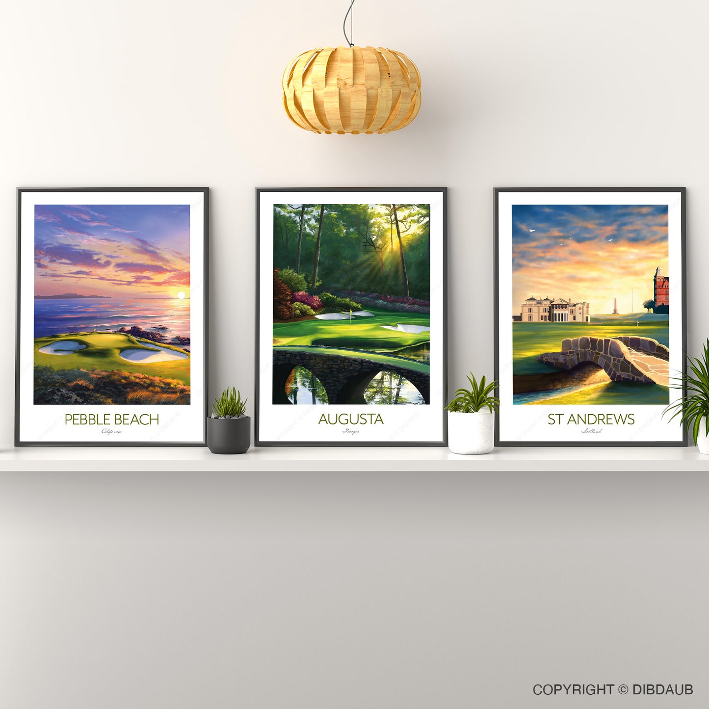 Three framed golf course prints on a wall with a wooden pendant light.