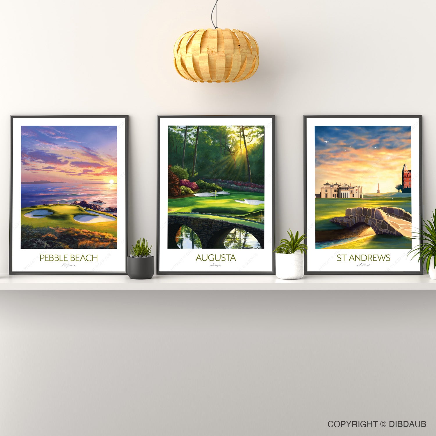 Three framed golf course prints on a wall with a wooden pendant light.