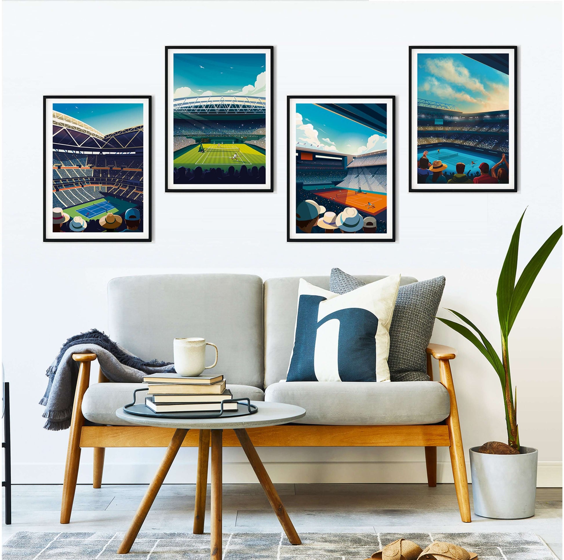 4 framed Grand Slam tennis artworks, displayed in a modern home above a sofa and indoor plant.