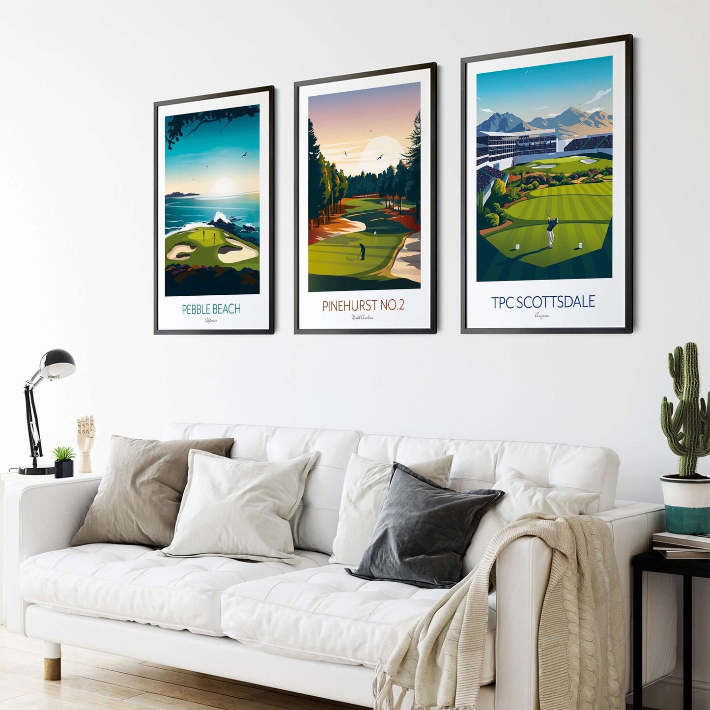 Set of 3 framed golf course prints of Pebble Beach, Pinehurst No 2 and TPS Scottsdale, hanging on a living room wall above a sofa.