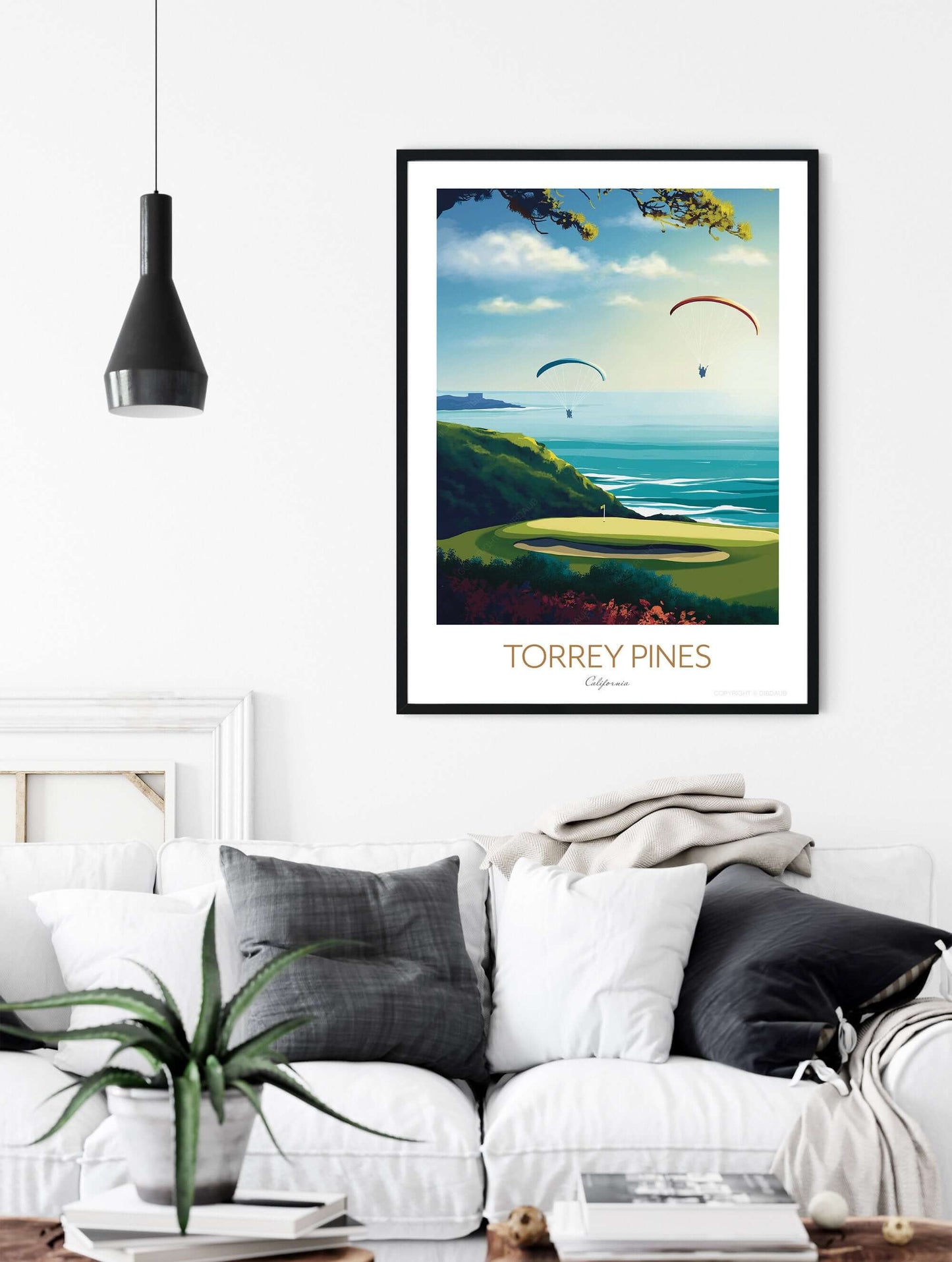 Torrey Pines framed golf course art print, hanging on a living room wall above a sofa.