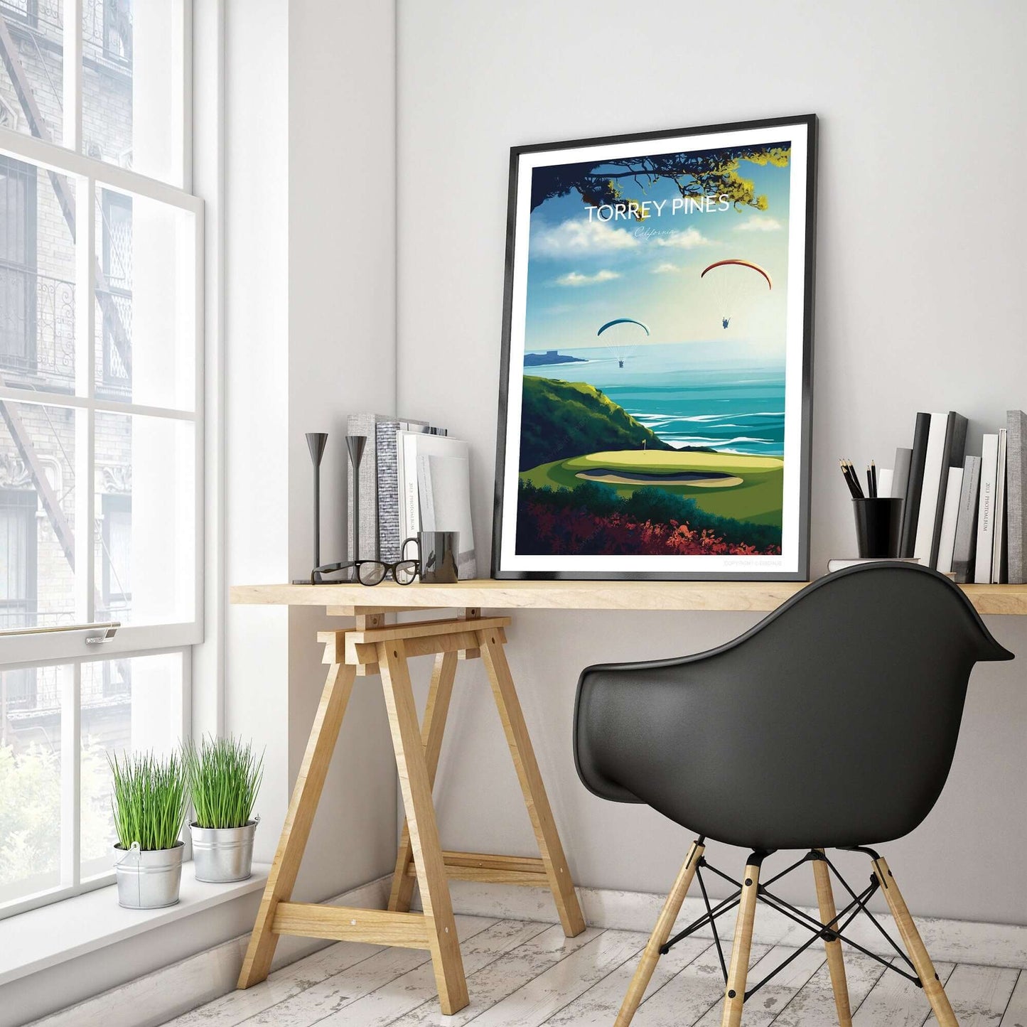 Golf poster of Torrey Pines, with a black frame placed on a home office trestle desk.