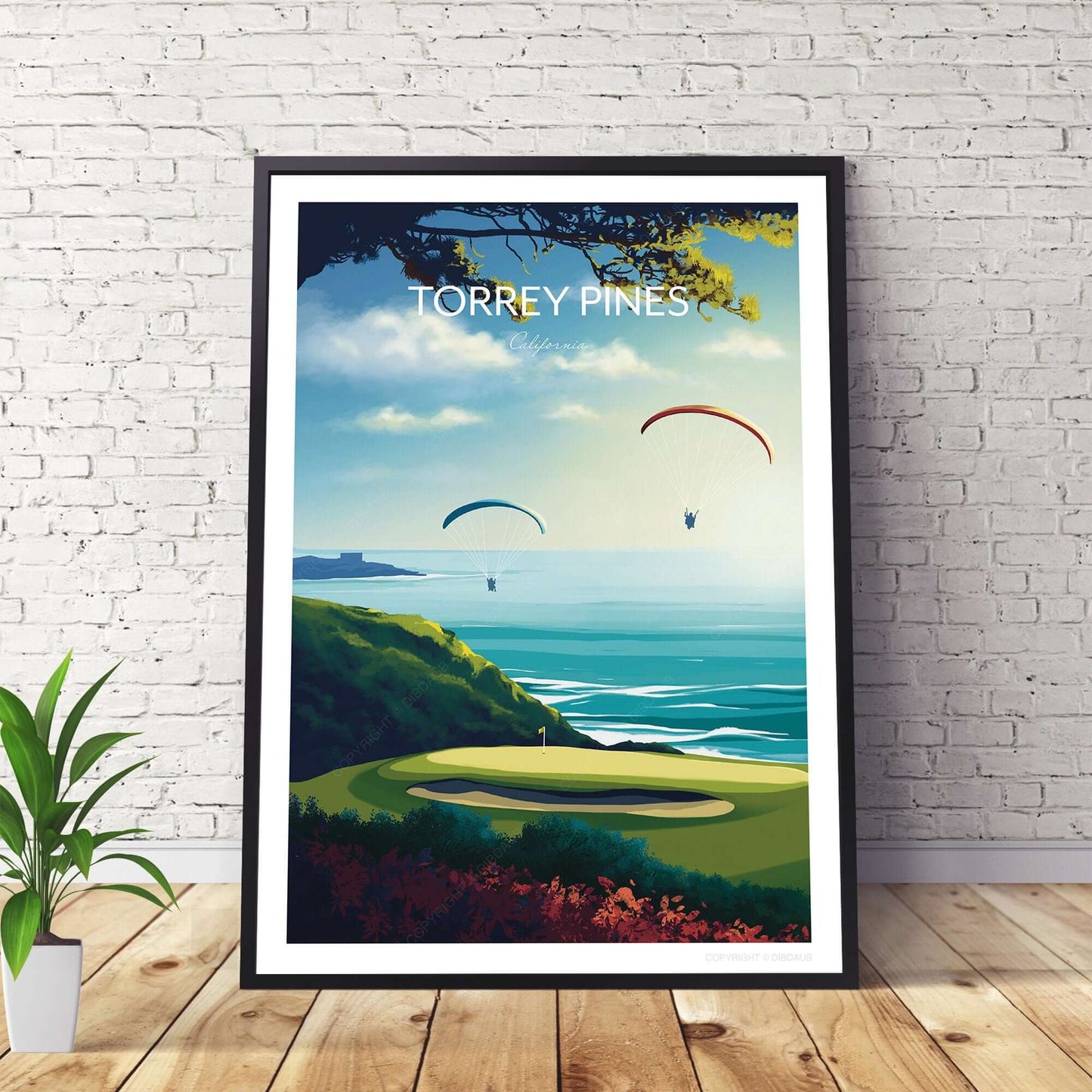 Torrey Pines Golf Poster in a black frame beside a plant on the floor.