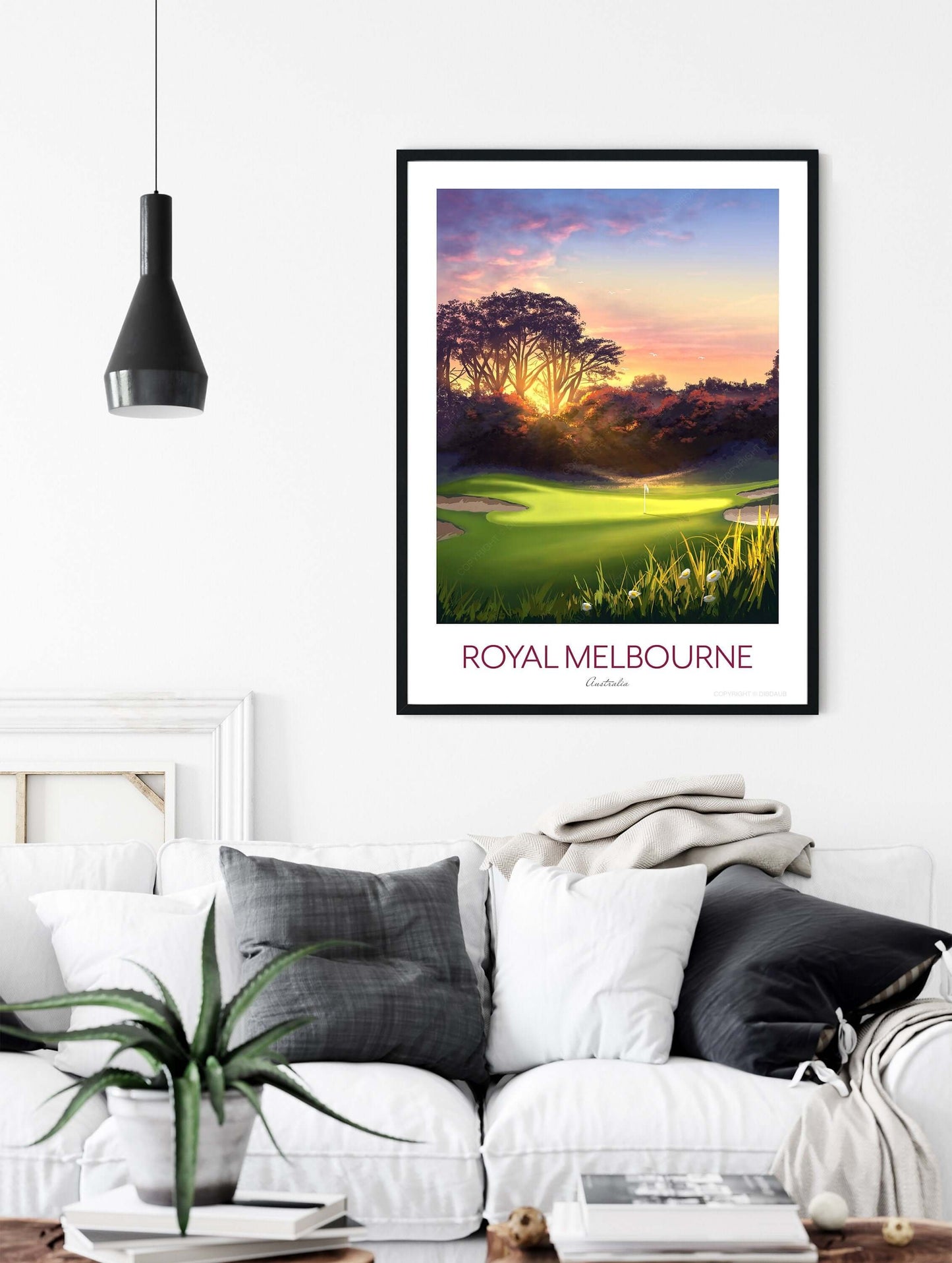 Royal Melbourne golf course art print, hanging in a living room above a sofa.