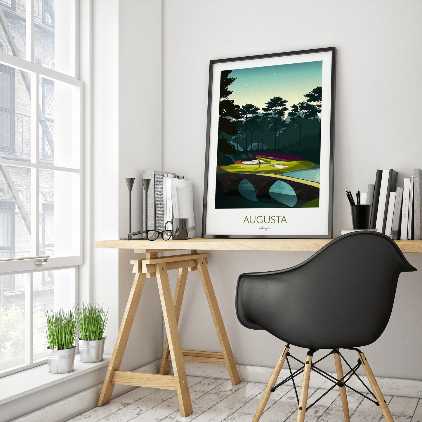 A golf print of Augusta National with a black frame and placed on a IKEA trestle desk within a home office.